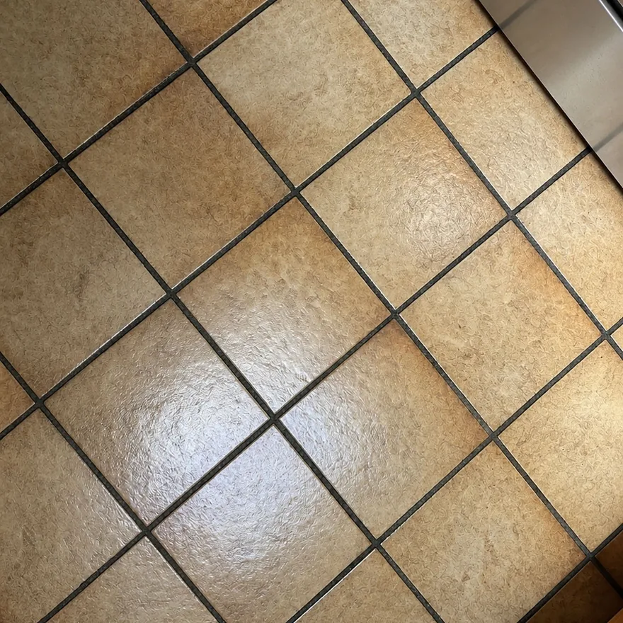 Dark, dirty tile grout before laser cleaning